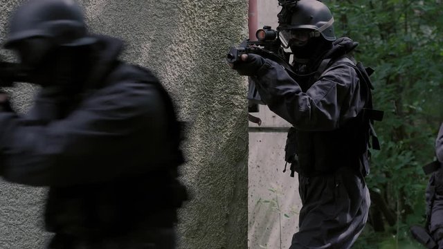 Close Up Special Force Team enter a rustical house.