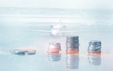 Abstract financial background. Coins on the table on the background of the aircraft.