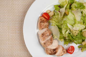 Stewed chicken fillet with tomato and cabbage salad.