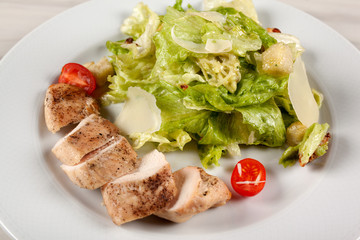 Stewed chicken fillet with tomato and cabbage salad.