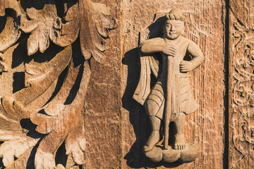 Archaeological, Close Up of carved art figures on old wood carvings on the wall temple at Shwe Nan...
