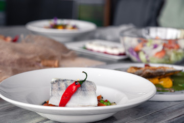 Many different dishes, fish, salads served on restaurant table. Concept banquet, buffet, party, trying new menu
