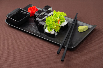 sushi on a black plate