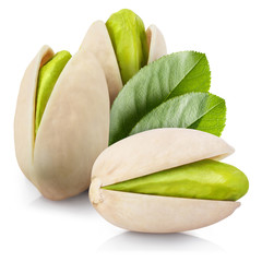 Delicious pistachios with leaves, isolated on white background