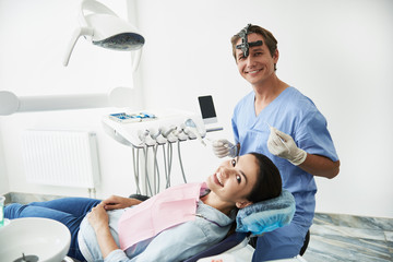 Charming young lady visiting dentist at modern clinic