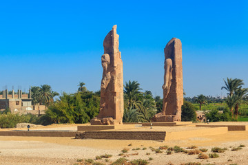 Recently raised quartzite Colossi of Amenhotep III at the Northern Gate of the temple of Luxor,...