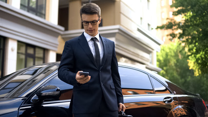 Irritated young male in formalwear chatting on phone, annoyed by problems