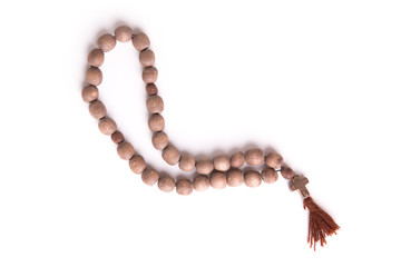 Wooden rosary necklace isolated on white background. Wooden rosary beads isolated over white.
