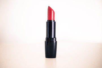 Professional red lipstick cosmetic product, white background