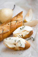 Sandwiches with cream cheese, pear and thyme on kraft paper. Top view food, close up