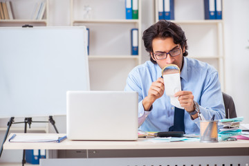 Young handsome businessman in budget planning concept 