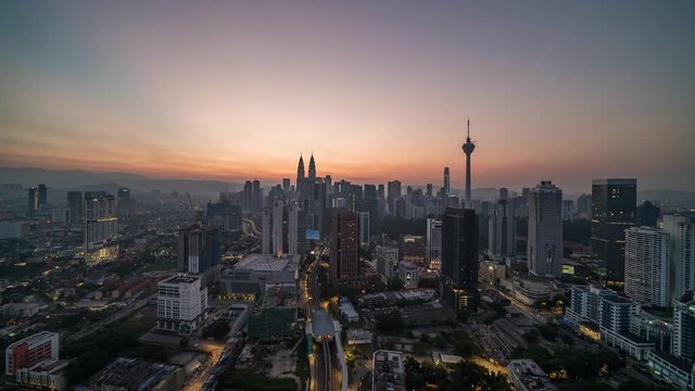 KUALA LUMPUR, MALAYSIA - MARCH 17, 2019: 4K Cinematic Sunrise Time Lapse Footage of Kuala Lumpur city skyline from the west side of the Malaysian capital.