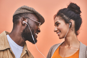 Cheerful nice couple listening to music together