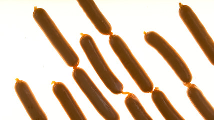 Sausages on white background, semi-finished products and meat with soy, flat-lay