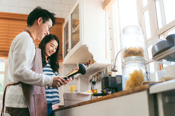 Attractive Asian couple marry family  preparing cooking food dinner together with happiness and freshful in home kitchen family ideas concept