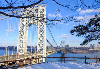 Fototapeta premium Abstract industrial bridge in winter season. Steel George Washington Bridge over Hudson River. Snow covered ground and bridge. Isolated architectural bridge.