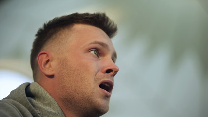 Young terrified man witnessing car accident, face close-up, awful situation