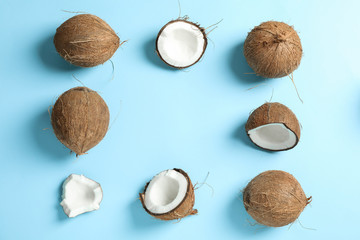 Flat lay composition with coconuts on color background, space for text