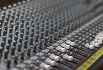 Mixing table with buttons and volume controls. Music and radio studio