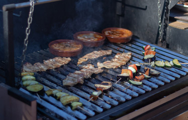 BBQ grill with bacon, vegetables and bowls with provolone cheese