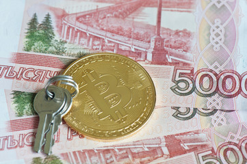 Golden bitcoin and two keys against 5000 rubles banknotes background. Cryptocurrency