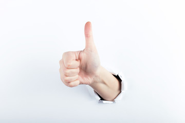 Female hand out of the hole in the paper. Isolate on white background.