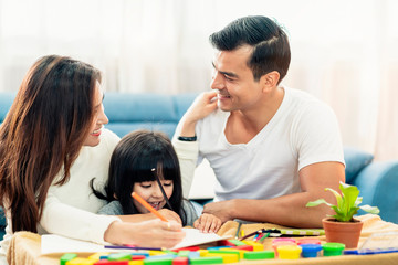happy family caucasian and asian mixed race with pretty daughter enjoy family time with toy  together living room home background