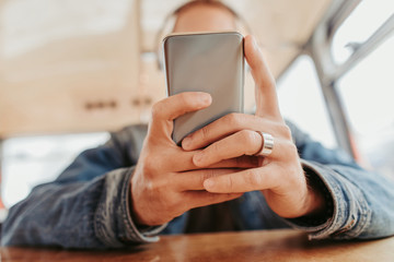Male listening music via smartphone in transport