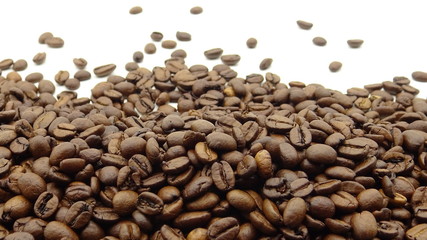 Close up of roasted coffee beans on white background
