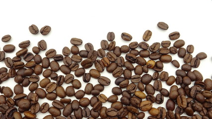 Close up of roasted coffee beans on white background