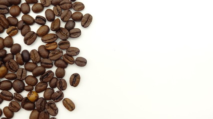Close up of roasted coffee beans on white background