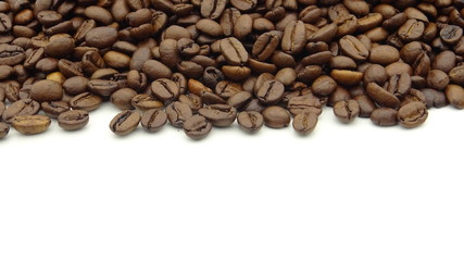 Close up of roasted coffee beans on white background