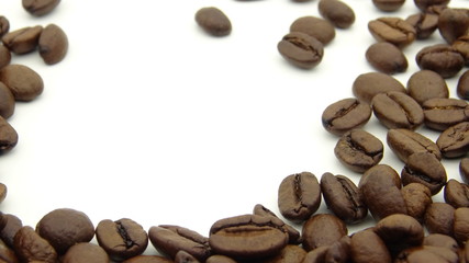 Close up of roasted coffee beans on white background