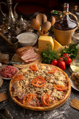 Pizza with minced meat, beacon and mushrooms for a restaurant menu.