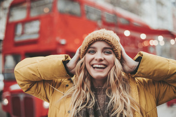 Young excited woman enjoying her walk on street