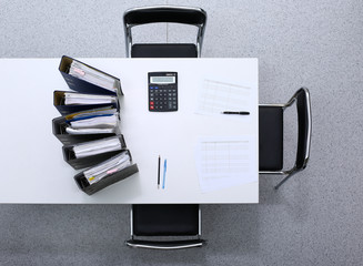 Binders with papers are waiting to be processed with bookkeeper. Internal Revenue Service inspector...