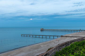 Beach, Bridge and The moon is rising at .Nim Seng Beach, Songkhla, Thailand.