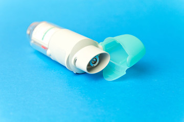  inhaler against asthma on blue background. COPD