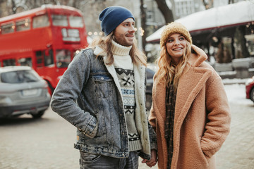 Happy smiling beloved couple walking on street