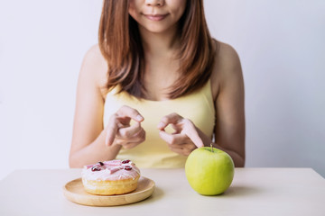 Woman making decision between healthy food and unhealthy food, Healthy and diet lifestyle concept