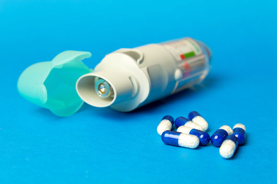  Inhaler And Pills Against Asthma On Blue Background. COPD