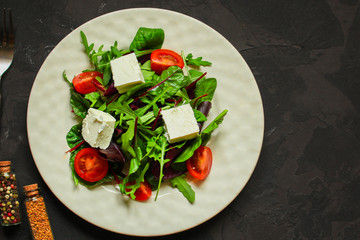 Healthy salad,  leaves salad mix in a white plate and cheese (green, juicy snack). food background - Image