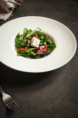 Healthy salad,  leaves salad mix in a white plate and cheese (green, juicy snack). food background - Image