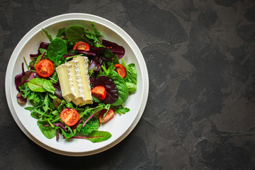 Healthy salad,  leaves salad mix in a white plate and cheese (green, juicy snack). food background - Image