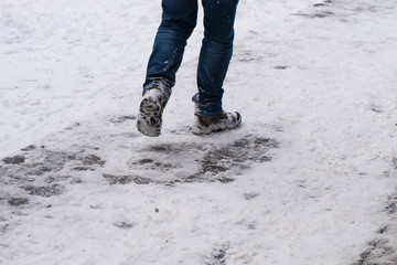 Feet in winter walking through the fresh snow