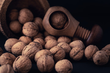 Italian nuts. Wooden nutcracker. Scattered nuts on a table with shallow depth of depth and depth.