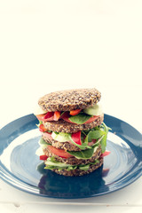Big Vegetarian sandwich on the plate. Snack at work. Shallow depth of field and graphic filter.