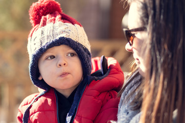 portrait of boy in jacket and hat with mum