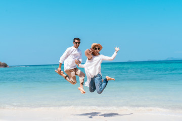 Young happy muslim couple white dress on seashore. Travel Vacation Retirement Lifestyle Concept....