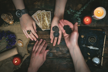 Tarot cards, magic book, fortune teller hands and thanks for fortune telling concept.